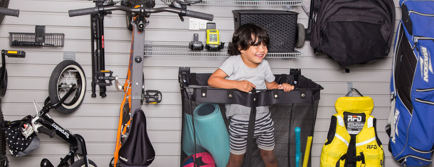 Child standing inside Stor-A-Wall Deep Mesh Basket